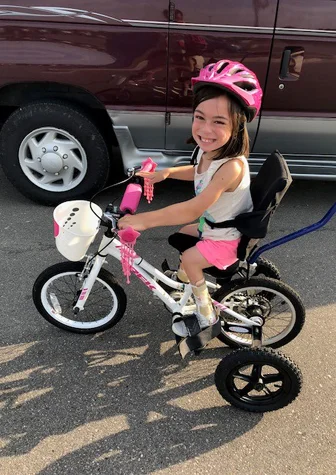 Alena riding her adaptive bike