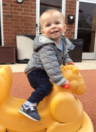 Cannon riding a rocking horse after treatment