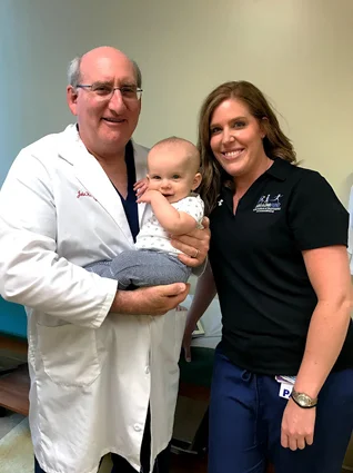 Cannon at a follow-up appointment being held by Dr. Herzenberg next to Physician Assistant Renee Hunter