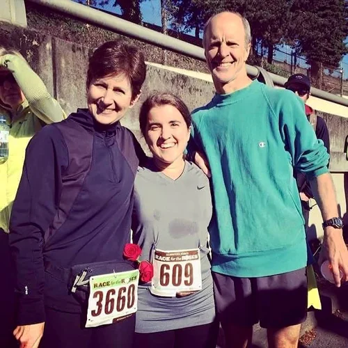 Hannah with her parents after completing a half marathon in less than 2 hours in 2014--exactly 10 years after her first surgery in 2004.