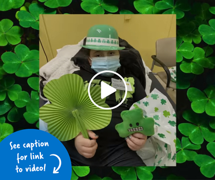 A patient holding St. Patrick’s Day trinkets on a clover background.