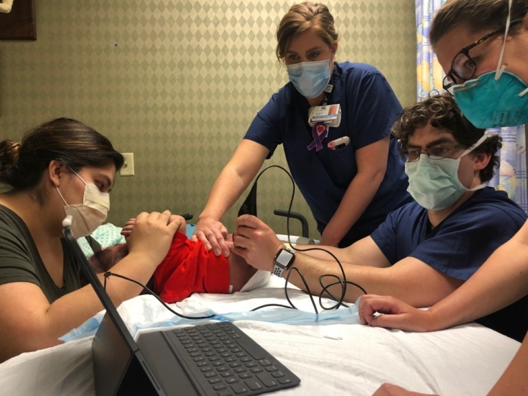 Dr. McClure checking the hips of an infant with fibular hemimelia and hip dysplasia by using the Butterfly iQ