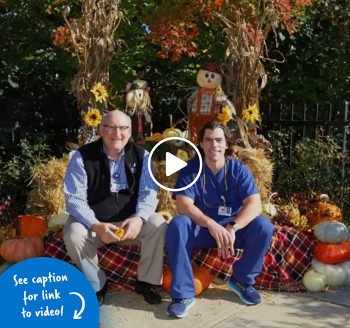 Dr. John Herzenberg and Dr. Philip McClure sitting outside with an autumn background