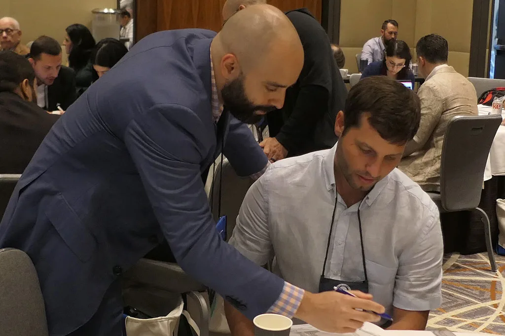  Dr. Michael Assayag assisting a participant with deformity correction exercises