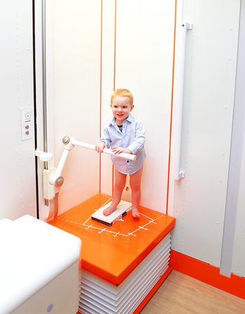 A boy standing in an EOSedge machine