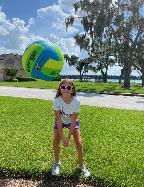 Emma playing volleyball outside