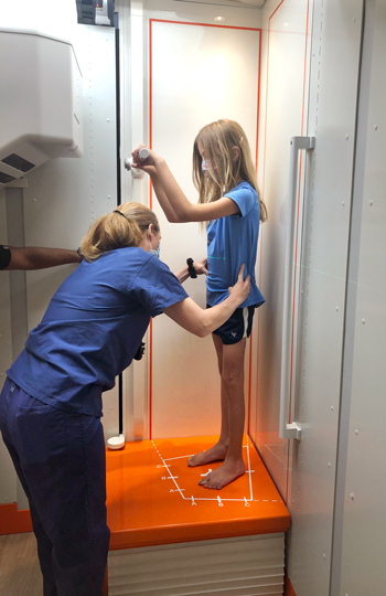 A girl standing in an EOSedge machine