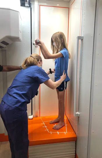 A girl standing in an EOSedge machine