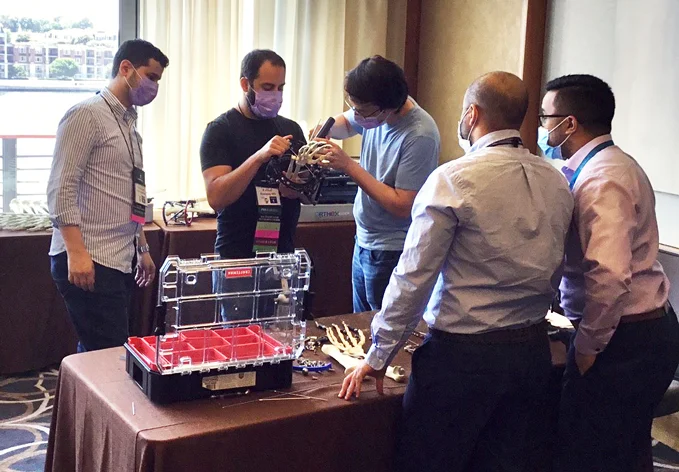 Dr. Michael Assayag teaching deformity correction on a sawbone model of a hand with an external fixator attached