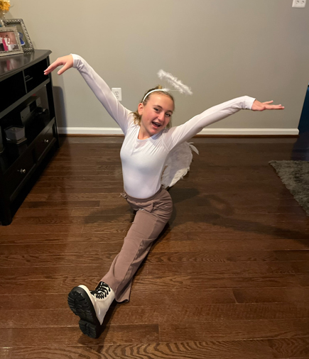 Ally wearing an angel halo doing a split