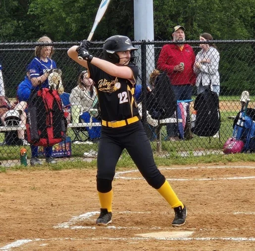 Ally at bat playing softball