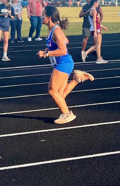 Aria running a race on a track