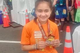 Aria with her finishing medal from a race