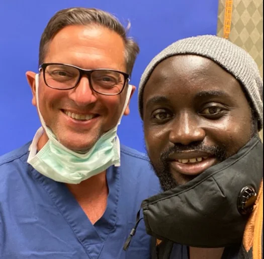 Ebou smiling with Dr. Christopher Bibbo