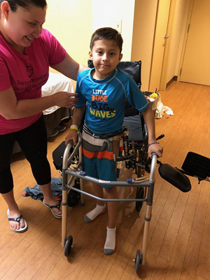 JJ wearing his external fixator and using a walker