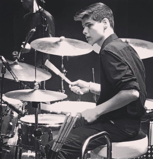 Jack hitting cymbals on a drum set