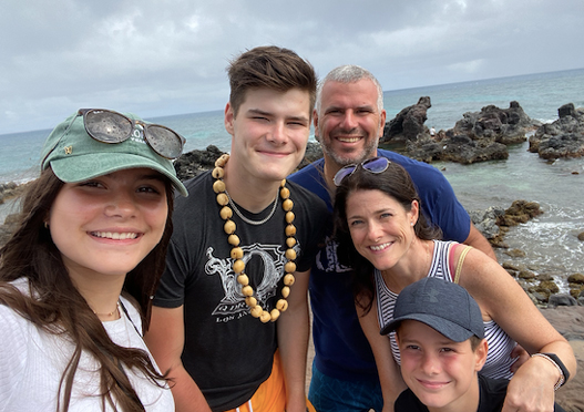 Jack with his family smiling at the beach