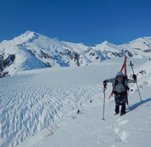 Keagan hiking with ski equipment in the snow