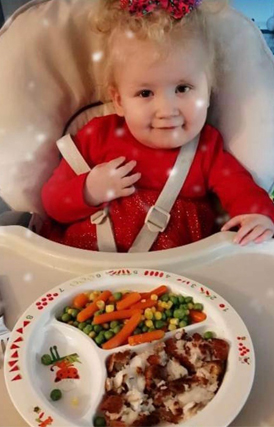 Lara sitting in highchair after treatment