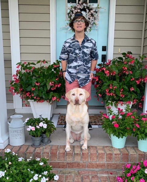 Preston standing with his dog at front door