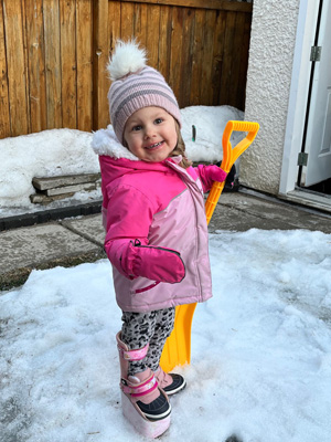 Riley shoveling snow with a shoe lift