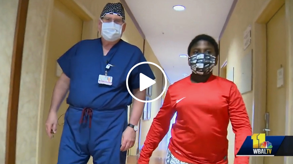 Thumbnail from a WBAL video of Dr. John Herzenberg walking with his patient Success Nworisa