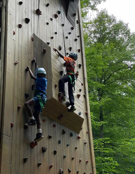 Sudan and a girl climbing an outdoor rock climbing wall