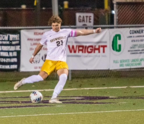 Thomas in unifrom kicking a soccer ball after treatment