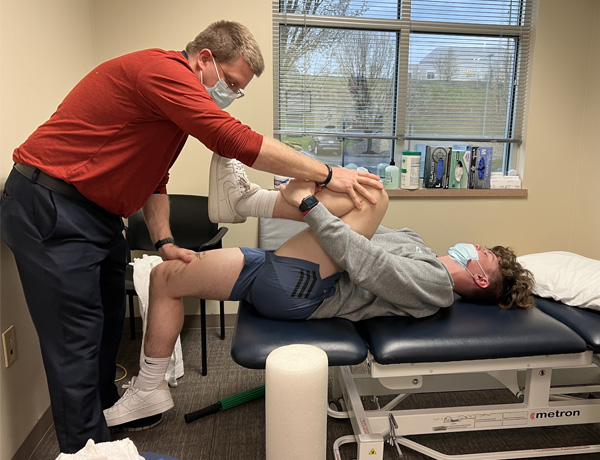 Thomas working with his physical therapist after frame removal