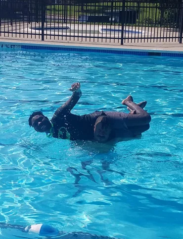 Zuri smiling while playing in a swimming pool