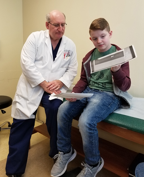 Aaron looking at his X-rays with Dr. Herzenberg