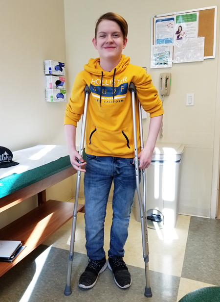 Aaron on crutches after a lengthening