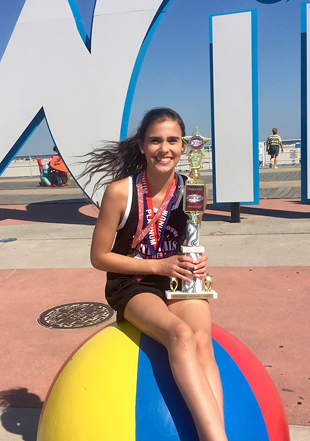 Cassidy as a teenager with her dance championship medals and trophy