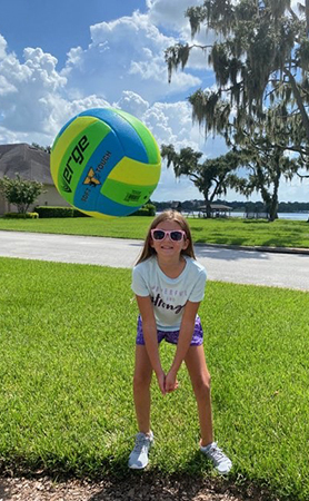 Emma playing volleyball outside