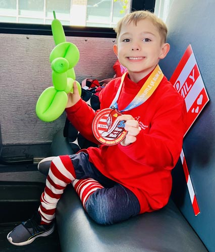 Jackson at the Ronald McDonald House Red Shoe Shuffle with his completion medal