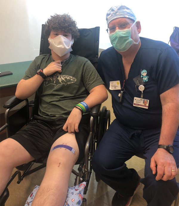 Zackary in his wheelchair with Dr. Herzenberg