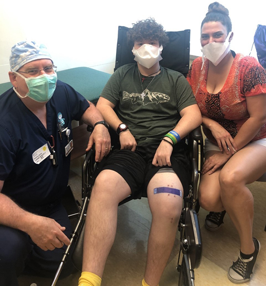 Zackary in his wheelchair with his mother and Dr. Herzenberg