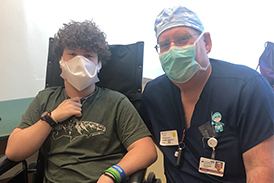 Zackary in his wheelchair with Dr. Herzenberg