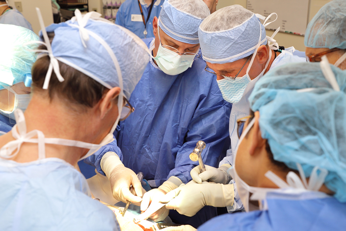 Dr. Shawn Standard teaching students how to perform a procedure during a cadaver lab