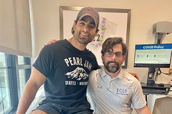 Ken as an adult in clinic with Dr. Philip McClure