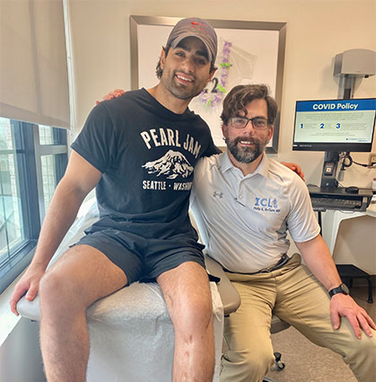 Ken as an adult with Dr. MClure in clinic