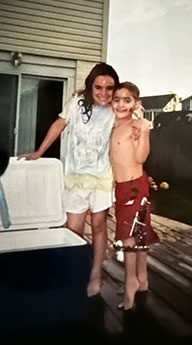 Ken as a boy wearing an external fixator outside with a family member