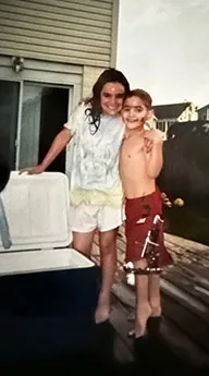 Ken as a boy wearing an external fixator outside with a family member