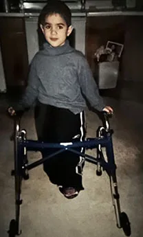 Ken as a boy using a walker
